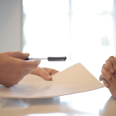 close up of documents with pen