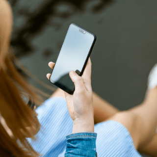 woman in dress using phone