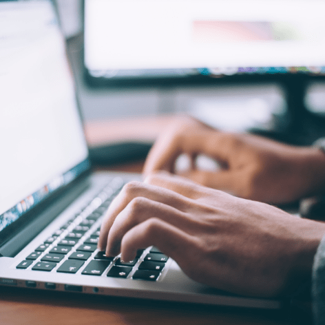 person typing on laptop computer
